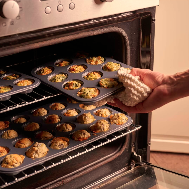 De Buyer 12 and 24 cup Muffin trays being taken out the over with baked savoury muffins in the trays.