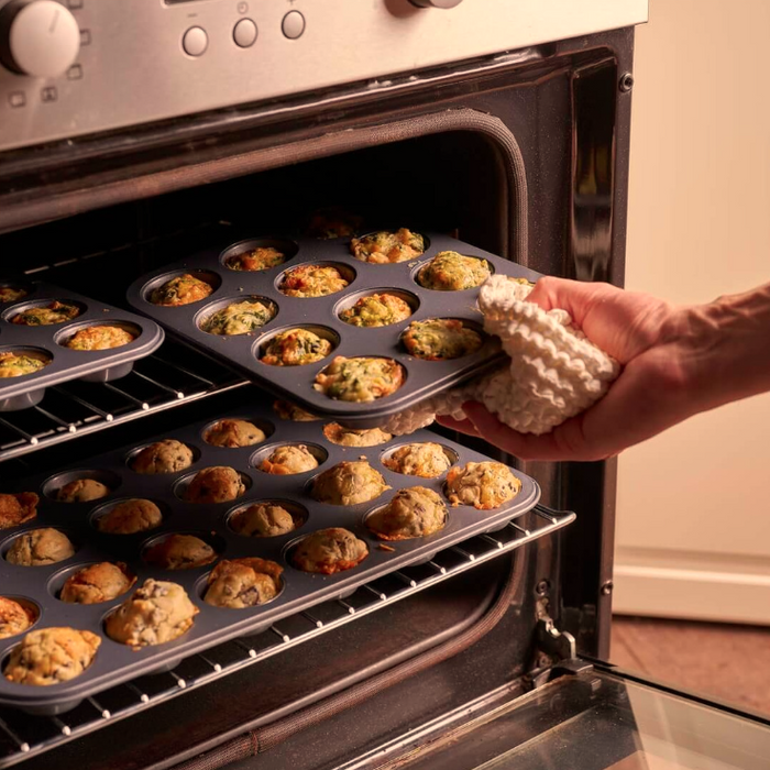 De Buyer 12 and 24 cup Muffin trays being taken out the over with baked savoury muffins in the trays.
