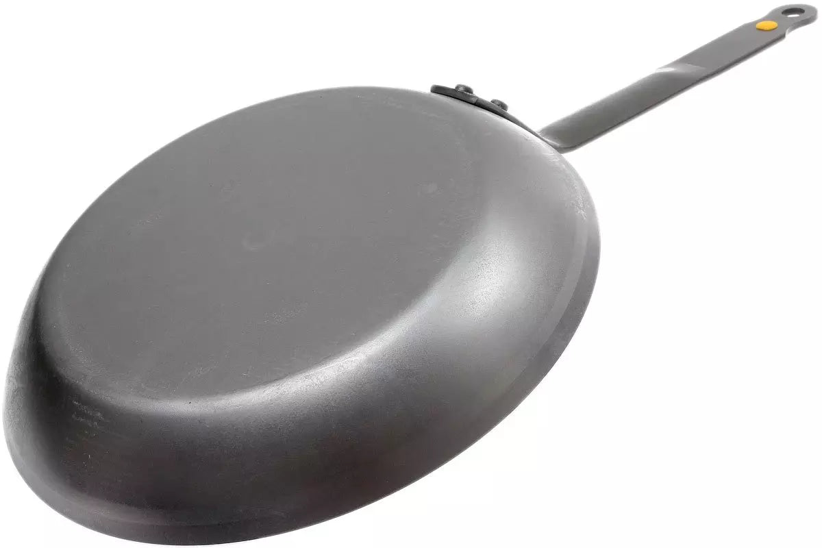 A dark gray Carbon Steel frying pan with a long handle, shown from an elevated angle on a plain white background.