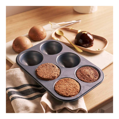 Individual rounded desserts made using the De Buyer six cup halfsphere tray